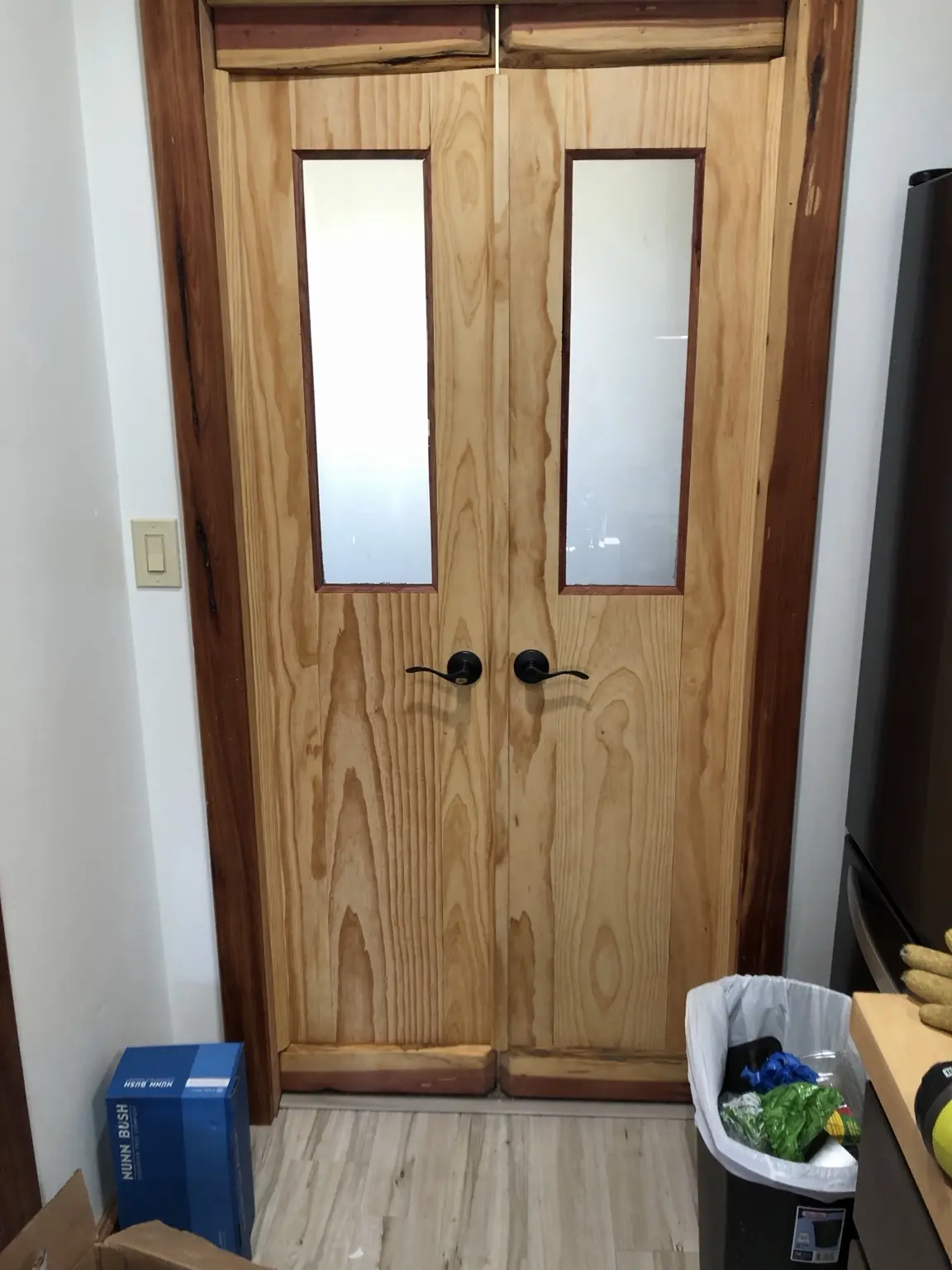 Installed custom wood double doors with frosted glass panels