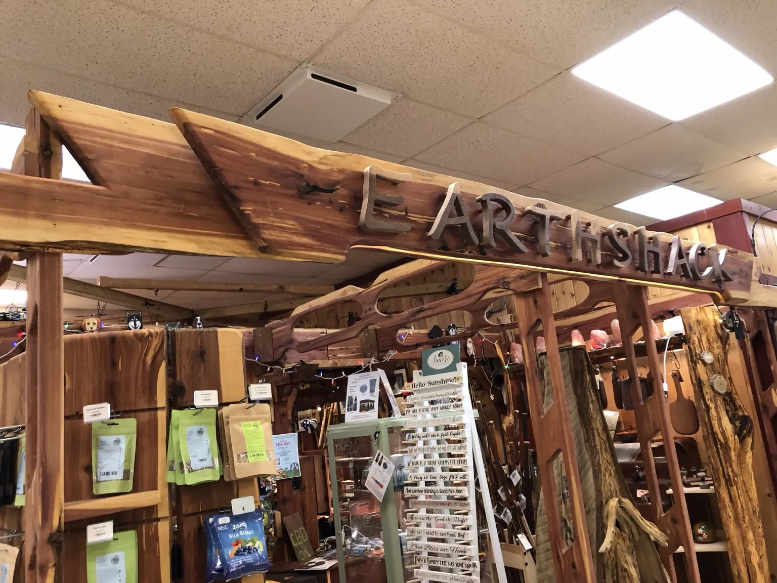 Installed live-edge Earth Shack retail display entrance sign