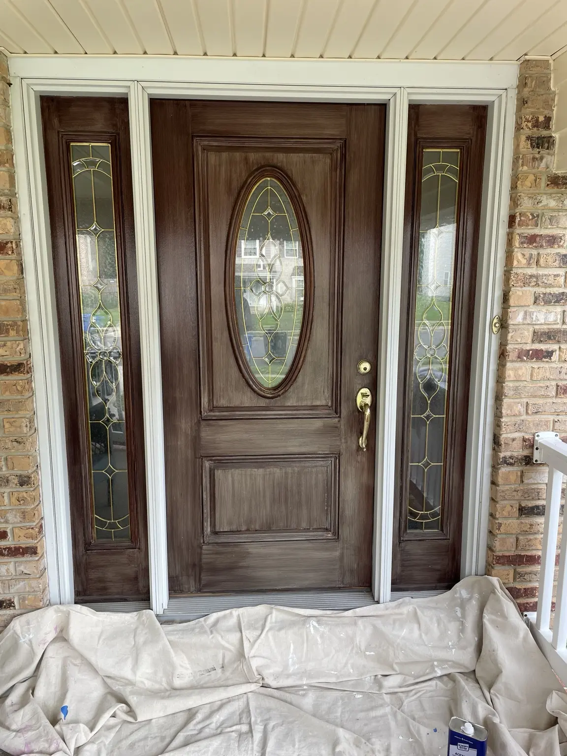 Front door and matching sidelights with a worn, uneven finish before refinishing